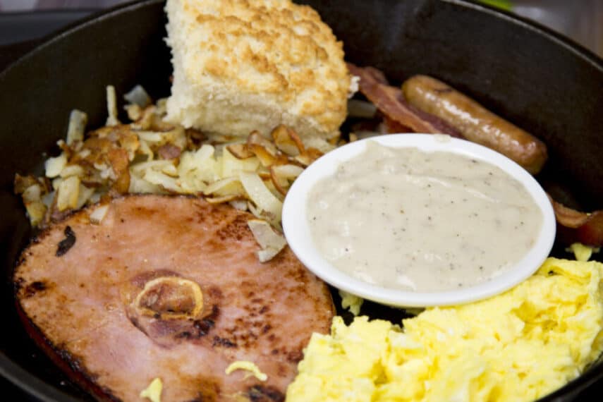 black bear camp skillet with ham eggs hash browns biscuit sausage bacon and gravy